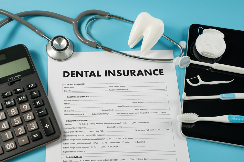 Image of a dental insurance form and dental tools